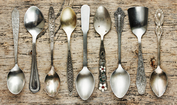 Vintage tea spoons collection on old wooden background