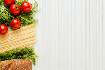 Ingredients for pasta on white wooden table