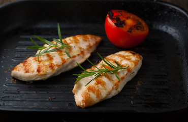 Grilled chicken breast with rosemary and tomatoes