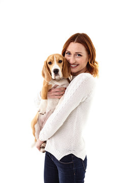 Attractive girl is hugging her loving puppy