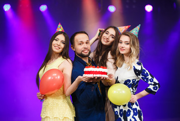 Happy birthday! Group of smiling friends gathered together with