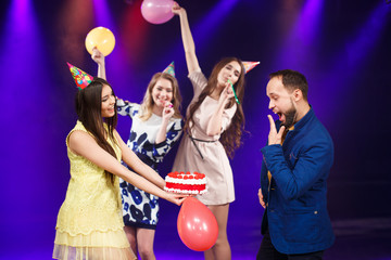 Happy birthday! Group of smiling friends gathered together with