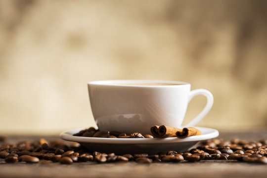 Coffee cup and saucer on a wooden table. Dark background