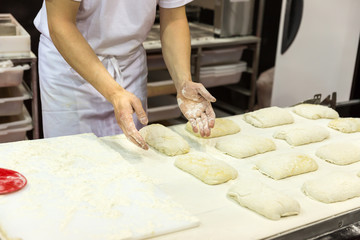 Baker working with dough