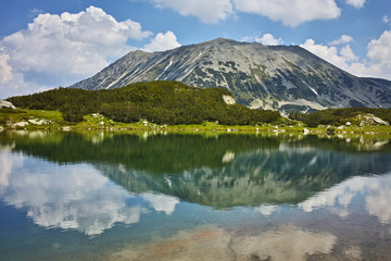 Panoramic view of Todorka peakand Reflection in Muratovo lake, Pirin Mountain, Bulgaria