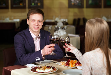 Couple toasting wineglasses in a luxury restaurant
