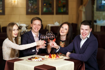 Friends at a restaurant drinking wine.