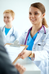 Fototapeta premium Medical team sitting at the table in modern hospital