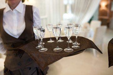 waiter with a tray welcomes visitors