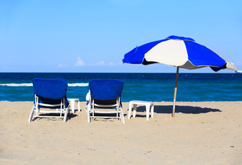Two chairs on sand beach
