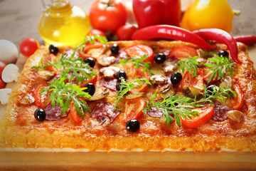Rectangle delicious pizza and vegetables on the table