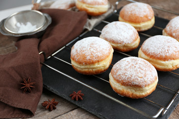 Fresh homemade donuts with powdered sugar, close up