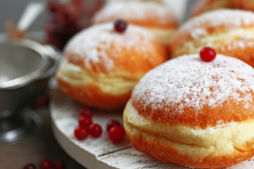 Fresh homemade donuts with powdered sugar, close up