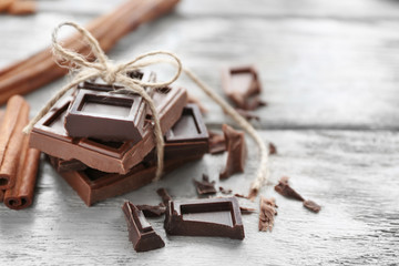 Chocolate pieces on wooden background