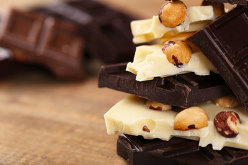 Mix of chocolate with nuts on wooden table