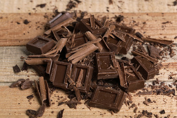 Chocolate pieces on wooden background