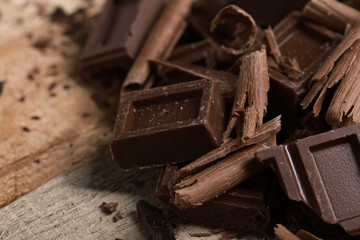 Chocolate pieces on wooden background