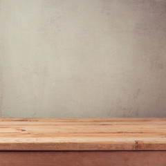 Empty wooden deck table over grey grunge wallpaper