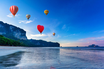 Hot-air balloons flying over sunset on the beach. Ao-Nang. Krabi. Thailand.