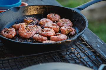 fried in butter with sesame seeds shrimp in a pan