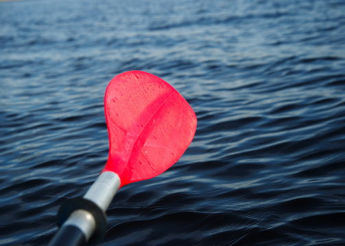 red paddle or oar of boat with lake background