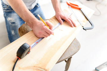 Man measuring piece of wood