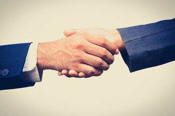 Handshake of businessman and businesswoman,  vintage tone