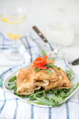 Nourishing pancakes with red fish and cream cheese
