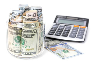 Fototapeta premium Money, US dollar bills, with calculator on white table