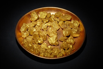 mound of gold  in copper plate