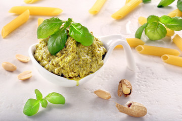 Fresh pesto with basil in a white bowl