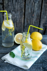 Cold refreshing lemonade with lemons and a thyme
