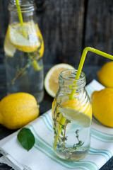 Cold refreshing lemonade with lemons and a thyme
