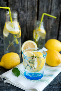 Cold refreshing lemonade with lemons and a thyme
