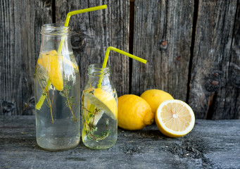 Cold refreshing lemonade with lemons and a thyme
