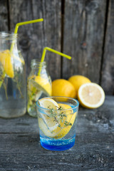 Cold refreshing lemonade with lemons and a thyme
