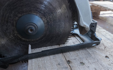 circular power saw. Carpenter Using Circular Saw for wood