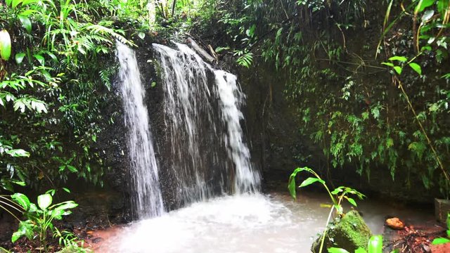 A waterfall in Paronella Park in Queenland Australia in the tropical north of Queensland Australia