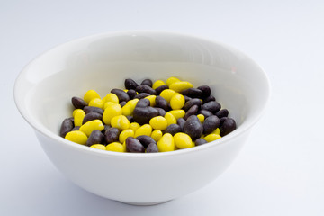 yellow and black jelly beans in the plate