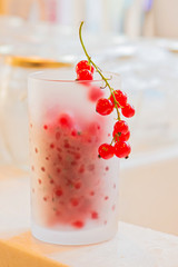 Fresh red currants in frosted glass