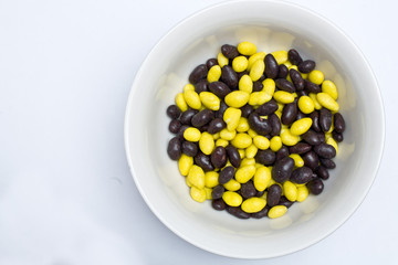 yellow and black jelly beans in the plate