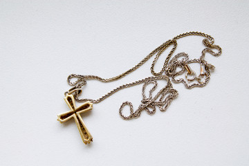 cross on a chain on white background