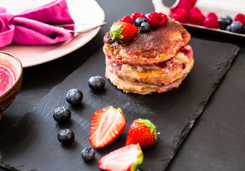 homemade tiramisu with red fruits over slate