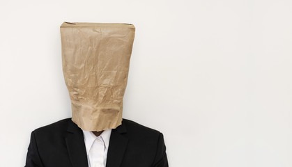 Businessman wearing brown paper bag