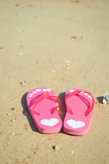Fototapeta na wymiar Tropical holiday of flipflops on sandy ocean beach vacation concept