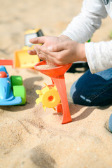 Child playing with beach sand toys