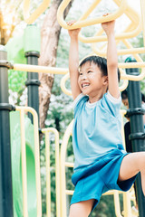 Obraz premium Boy play with hang yellow bar.