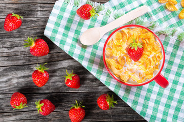 corn flakes with milk and strawberries, top view