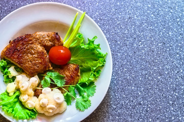 juicy grilled pork chop (neck cut) with greens