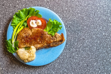 juicy grilled pork chop (neck cut) with greens